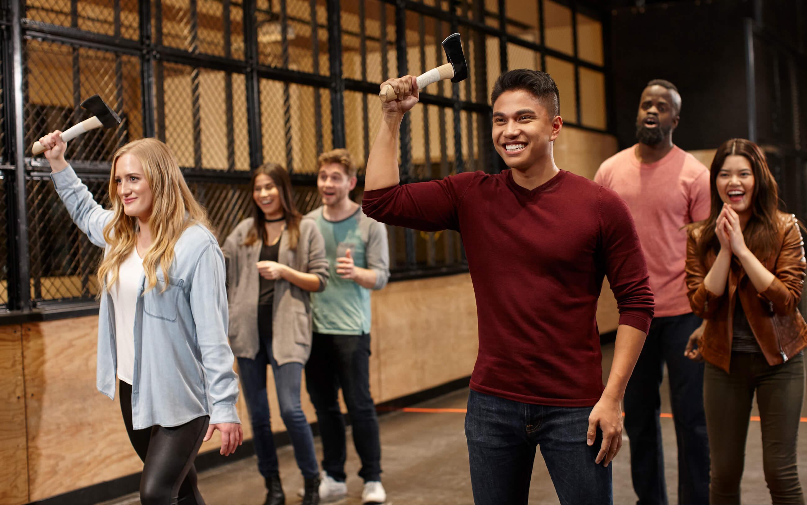 Friends excitedly playing Axe Throwing.